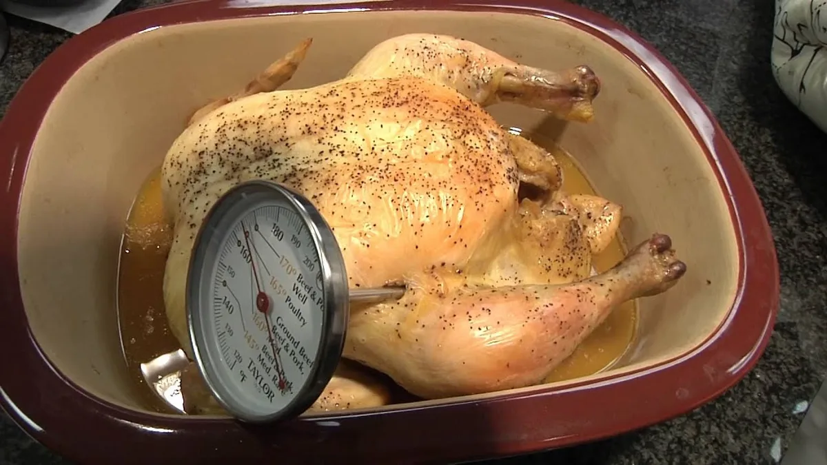 instant read thermometer checking chicken thigh